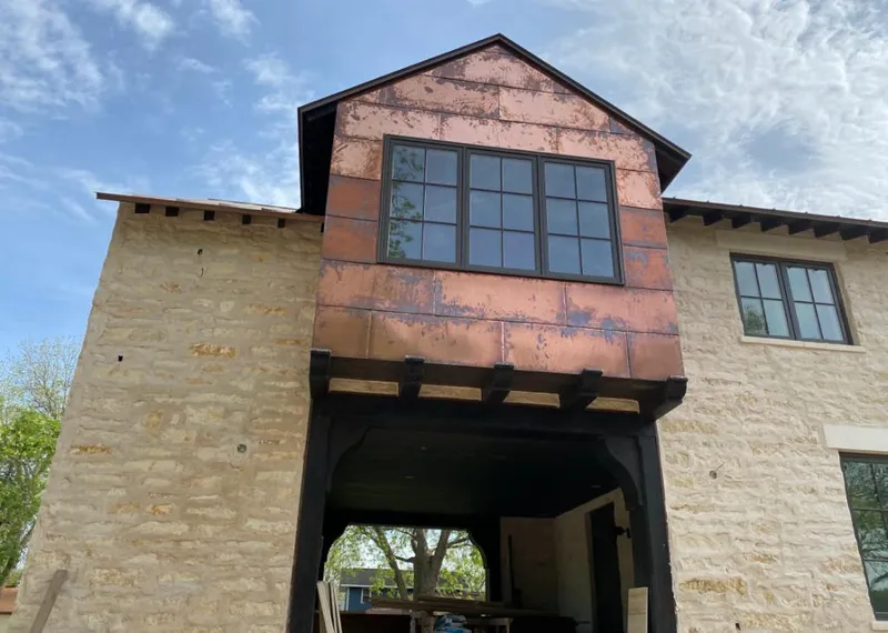 Copper metal panel facade on a stone building for Roof Repair in West Vero Corridor