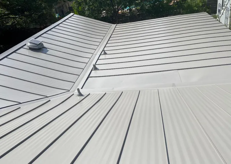 Solar attic fan installed on a metal roof for Roof Ventilation in West Vero Corridor